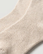 Macro close-up of the cashmere knit showing the soft, loose gauge