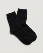 The 100% Cashmere Bed Socks in Black, a pair laid flat and overlapped