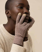 Wildfool first-shear lambswool tech gloves in charcoal — overhead flat lay on cream linen