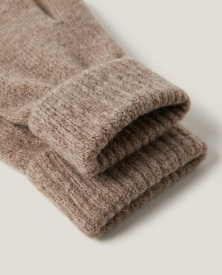 Wildfool first-shear wool gloves worn on model — three-quarter portrait in winter light