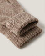 Wildfool first-shear wool gloves worn on model — three-quarter portrait in winter light