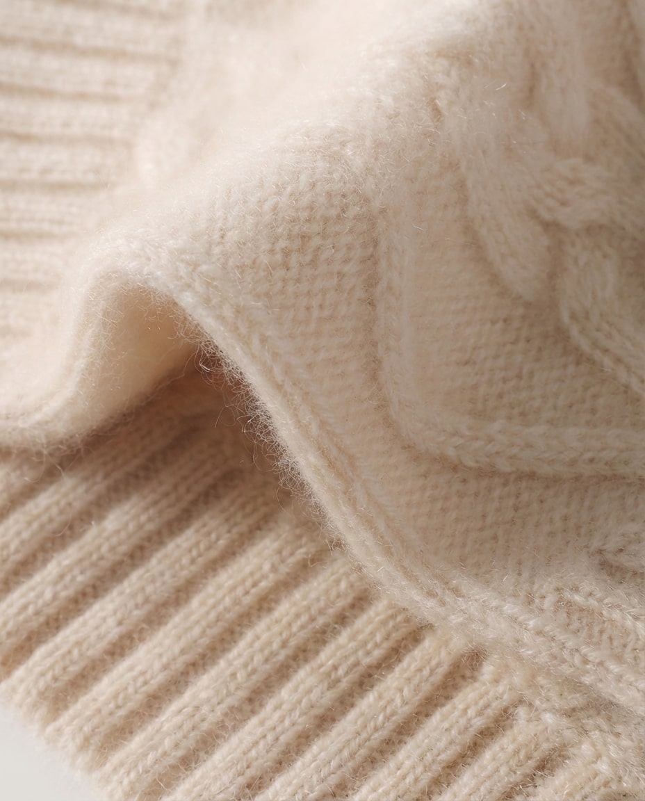 Wildfool cashmere wrist warmers tucked into a coat pocket — travel shot