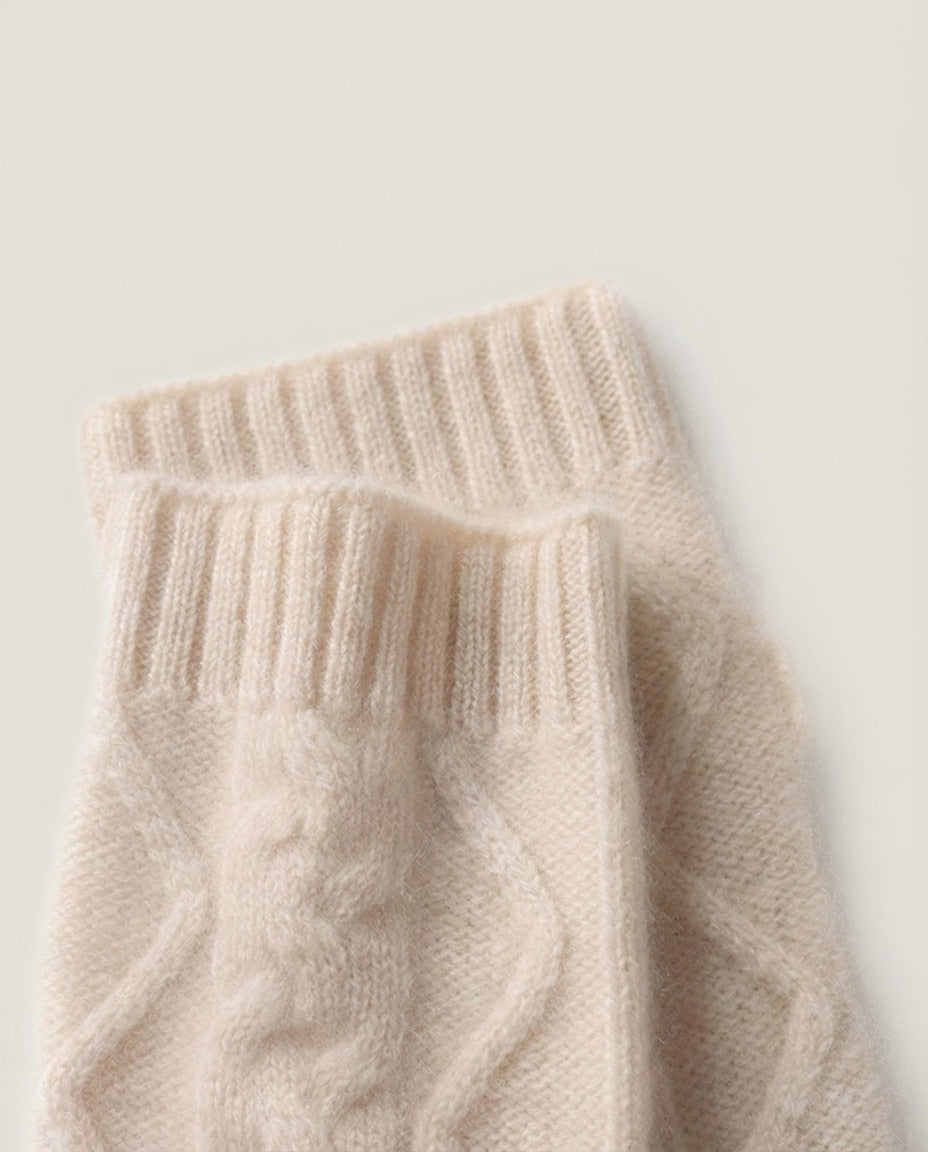 Both wrist warmers displayed showing the cable twist and open thumb slot