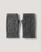 Wildfool Alashan baby cashmere wrist warmers in oat — overhead flat lay on cream linen