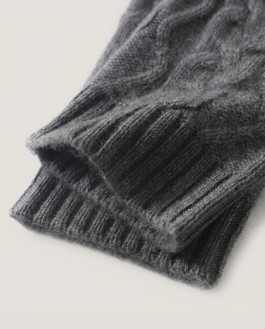 Cable knit wrist warmers worn on hands typing at a desk — lifestyle morning shot