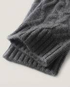 Cable knit wrist warmers worn on hands typing at a desk — lifestyle morning shot