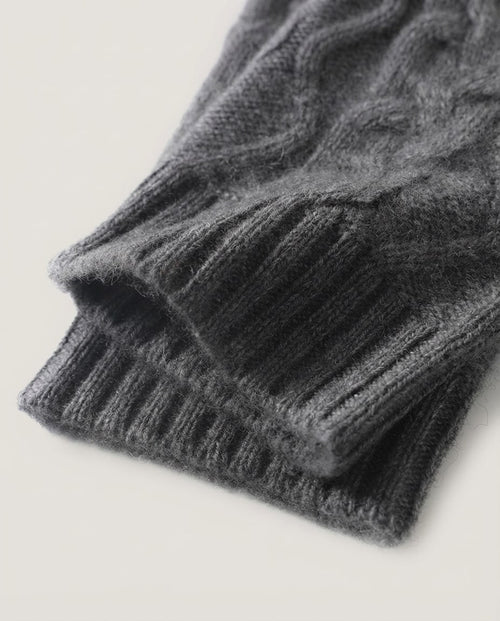 Cable knit wrist warmers worn on hands typing at a desk — lifestyle morning shot