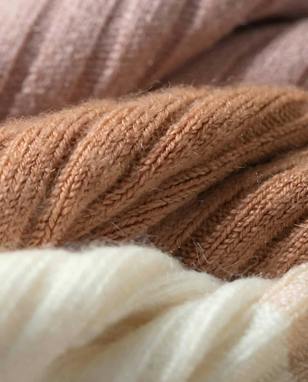 Three pairs of merino crew socks fanned out showing the neutral color range