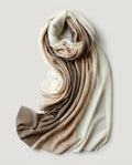 Macro close-up of the cable-knit twist showing undyed cashmere in mixed natural tones