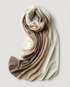 Macro close-up of the cable-knit twist showing undyed cashmere in mixed natural tones