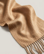 The Dune 100% Cashmere Scarf in Camel, laid flat with the fringe showing