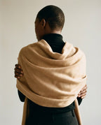 Scarf draped over one shoulder — side view showing the ripple catching evening light