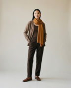 Wrap used as a light throw on an airplane seat — travel lifestyle shot