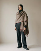 Heritage wool wrap worn over the shoulders as a shawl — three-quarter portrait