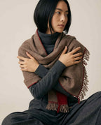 Wildfool Hohhot heritage lambswool wrap in deep camel — full flat lay on cream linen
