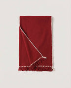The Hohhot Heritage Wool Wrap in Burgundy, folded in half and laid flat