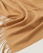 Wildfool blanket-wrap folded on the passenger seat of a car — travel shot