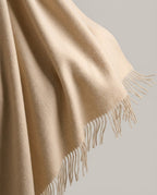 Blanket-wrap spread across a lap on a park bench — lifestyle rest shot