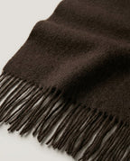 Scarf held by one end to show the slim 31cm width and light drape