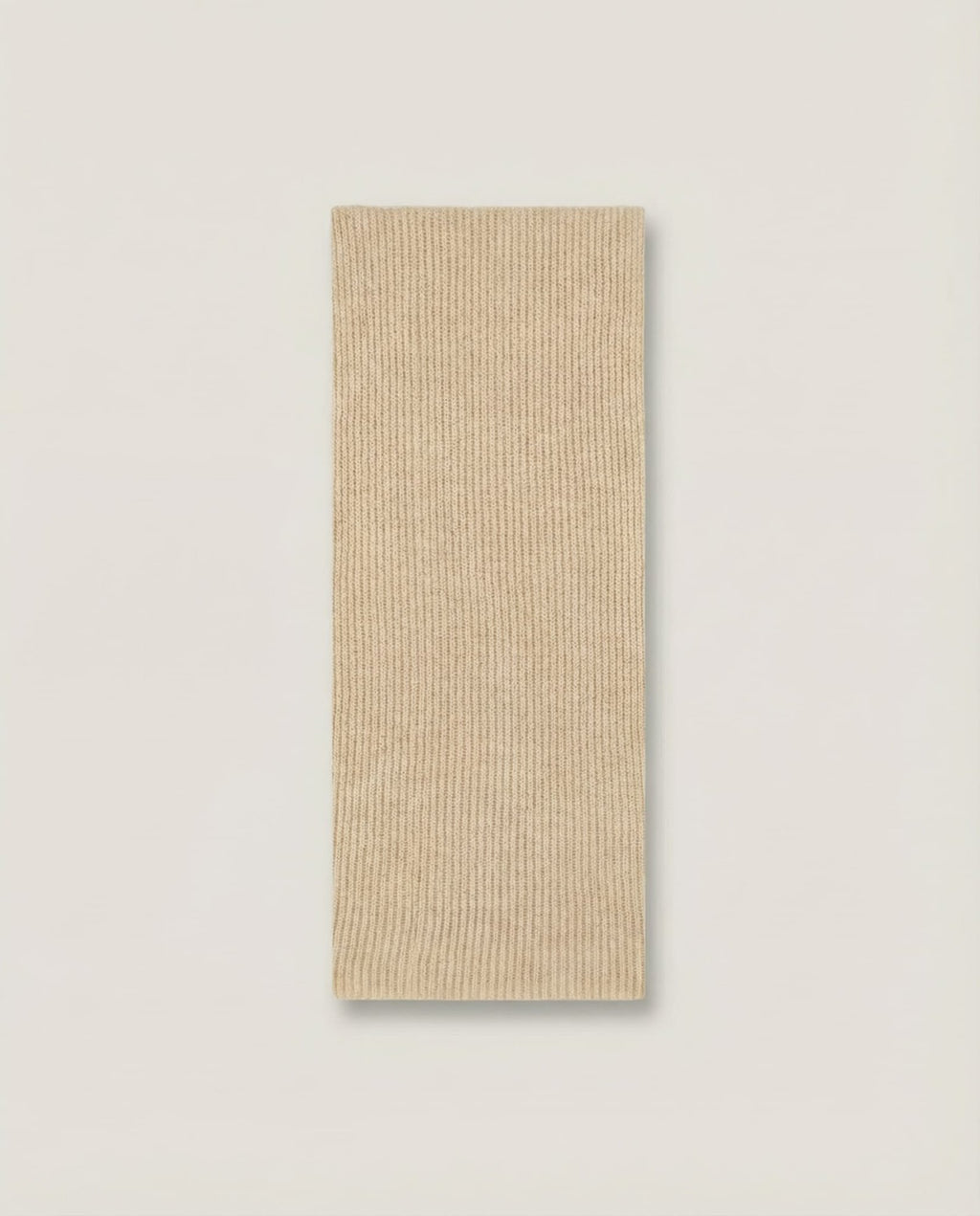 Collar worn looped once and tucked into a crew-neck sweater — layering shot