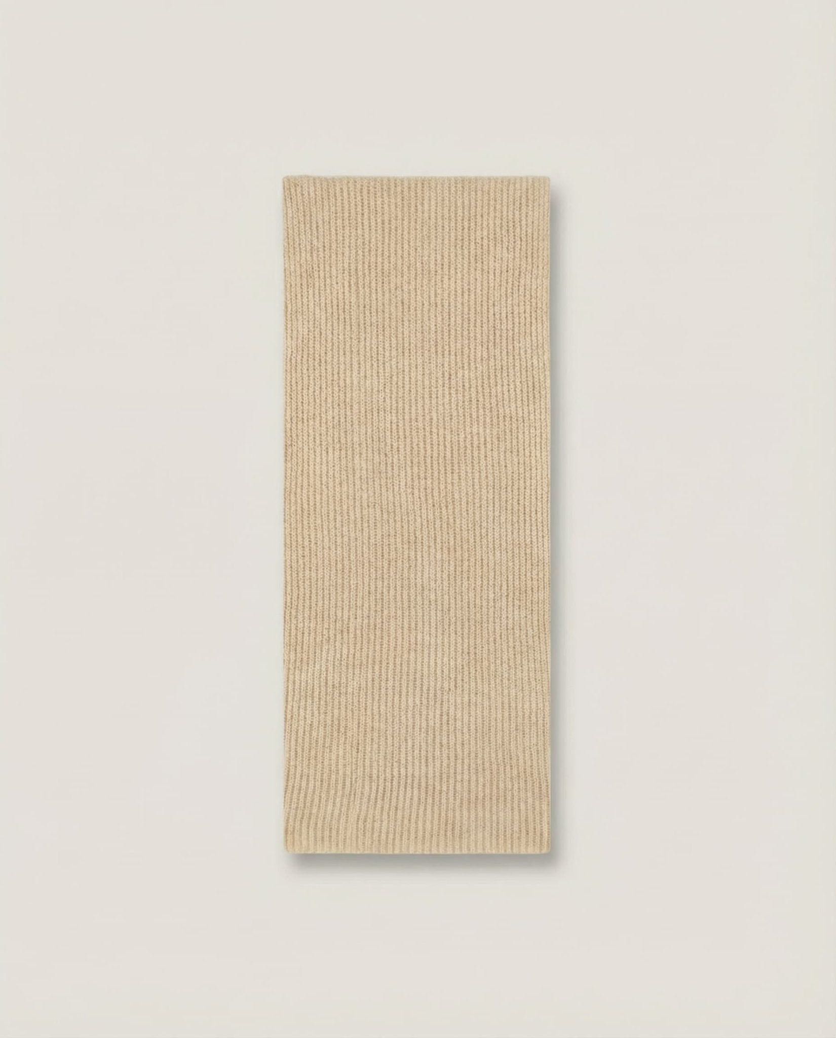 Collar worn looped once and tucked into a crew-neck sweater — layering shot