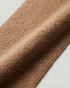 Wool commuter collar worn tucked into a coat — front view showing only the top edge visible