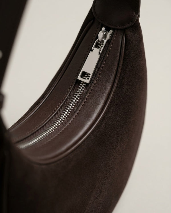 Cassis Crescent Bag zip — silver-tone zip set in smooth leather piping