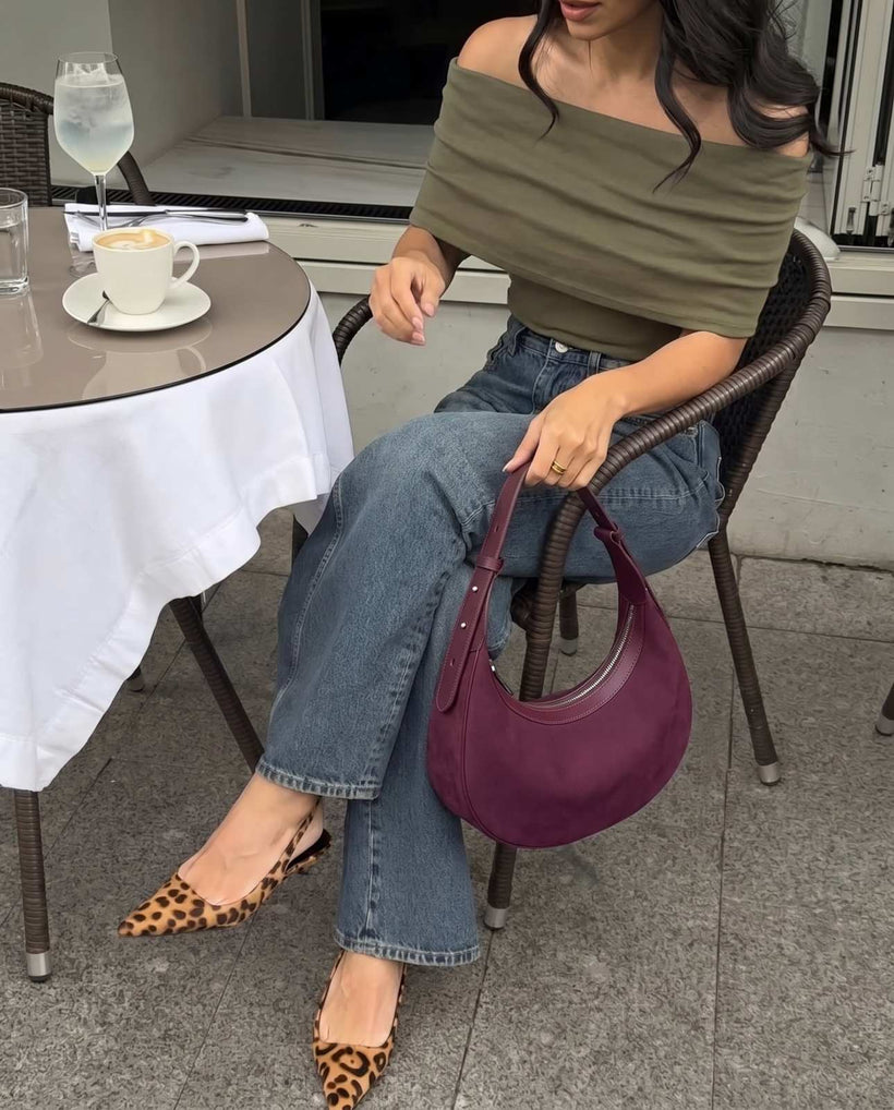 The Cassis Crescent Bag in Purple, styled